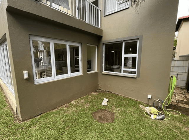 White aluminium windows and sliding doors installed on a modern home exterior